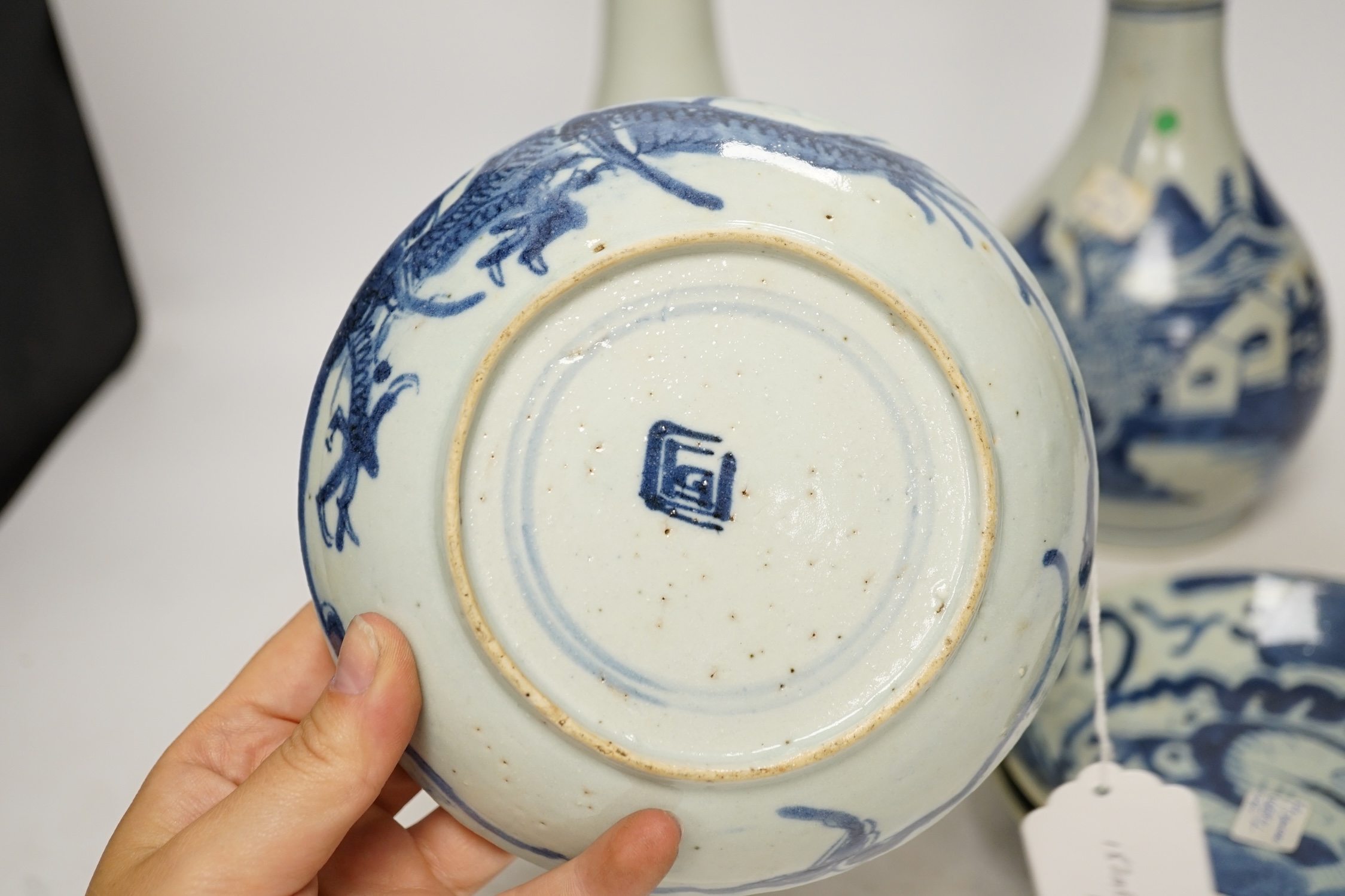 Two 18th century Chinese blue and white guglet bottles and four 19th century Chinese blue and white 'dragon' dishes, tallest 25cm. Condition - fair